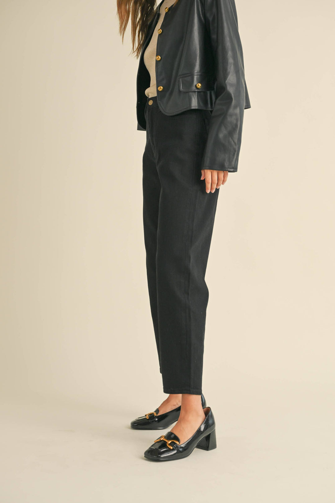 Person wearing tapered cotton pants in black.