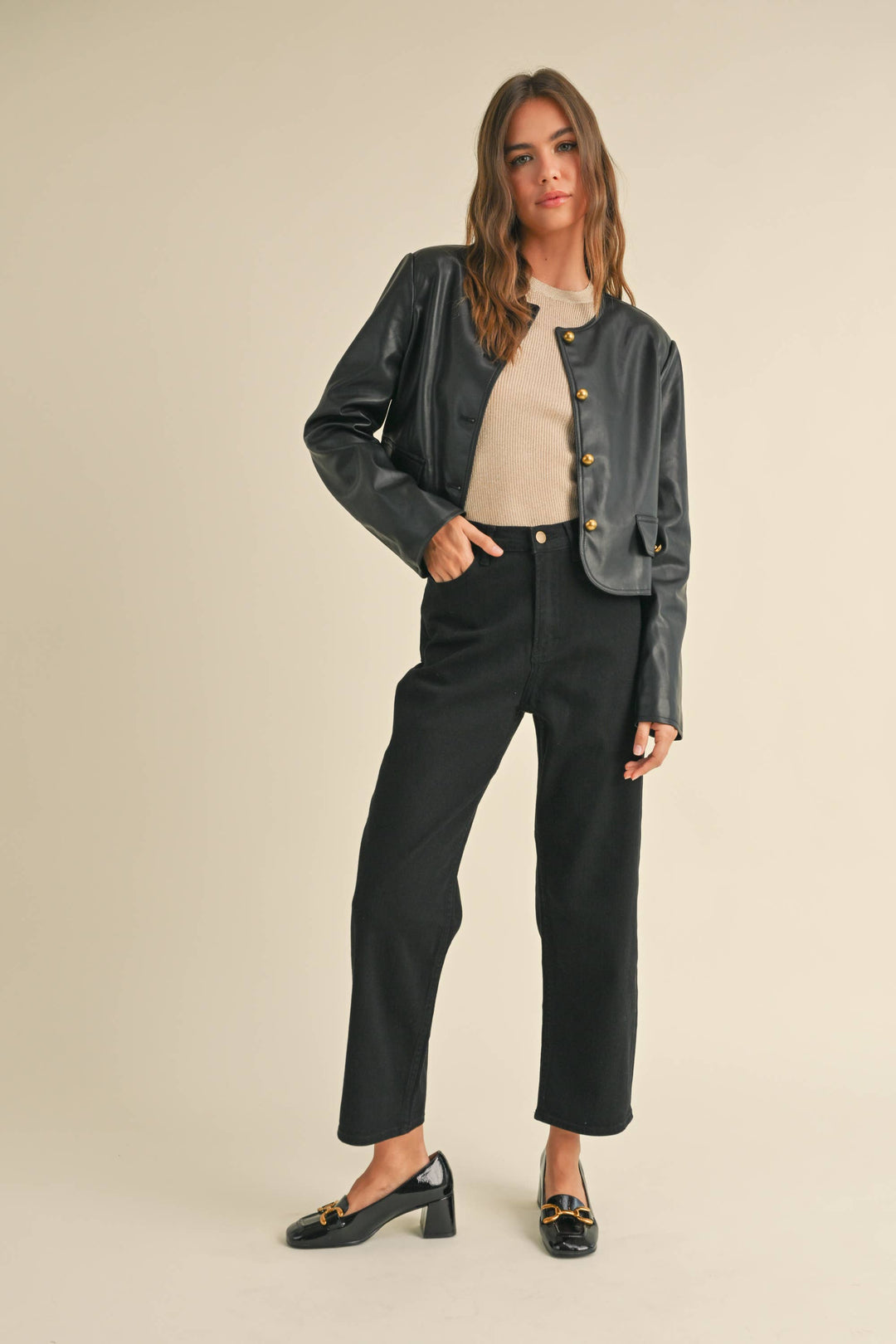 Person wearing tapered cotton pants in black.