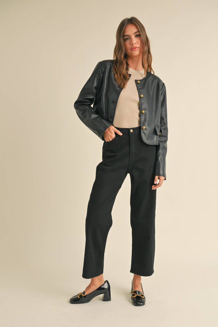 Person wearing tapered cotton pants in black.