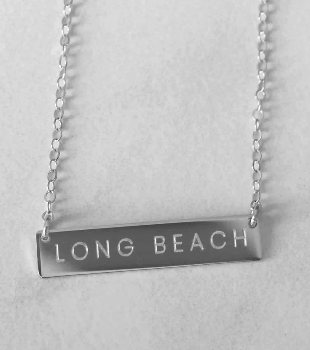 Black and white image of a chain with the words Long Beach on it