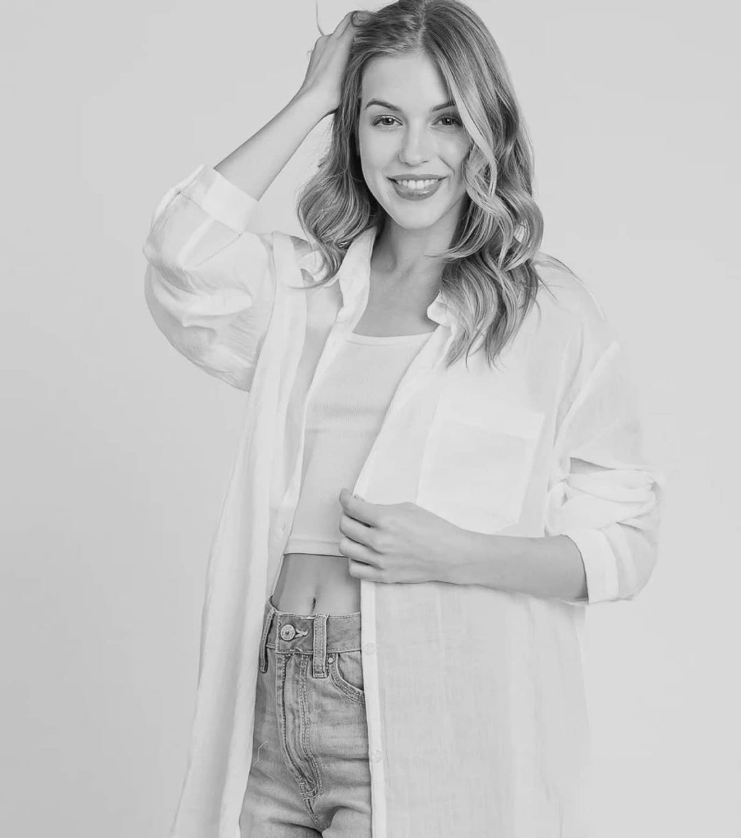 Black and white image of a person wearing oversized shirt